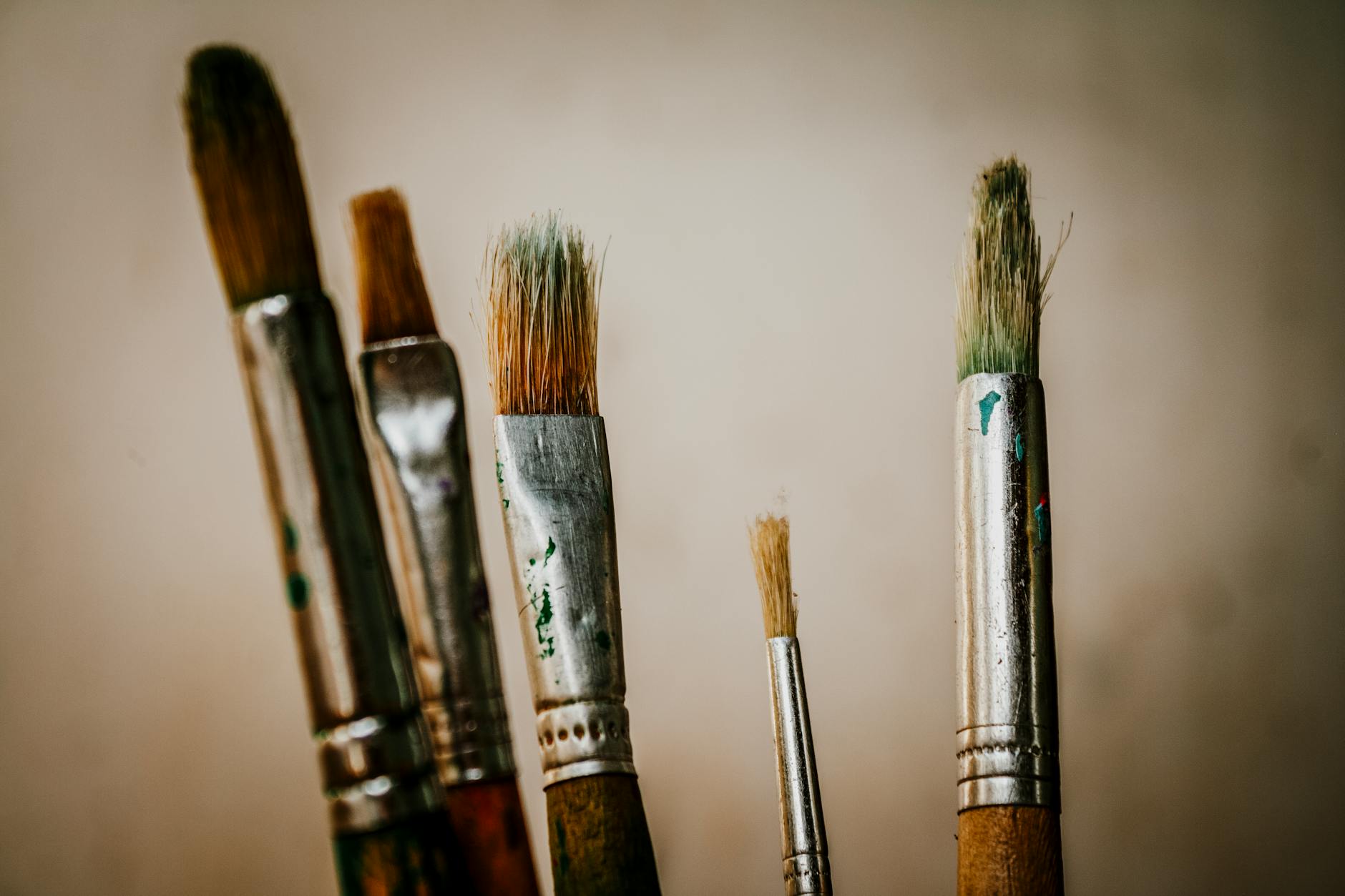 a close up of a group of paint brushes